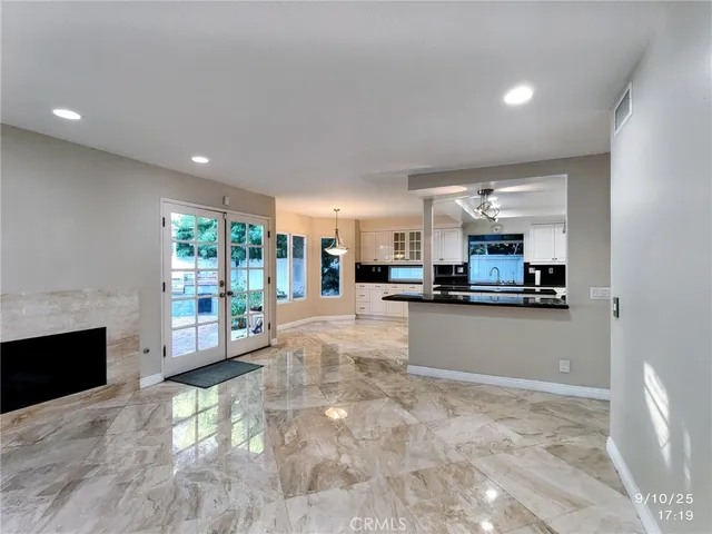 a kitchen with stainless steel appliances a refrigerator sink and microwave