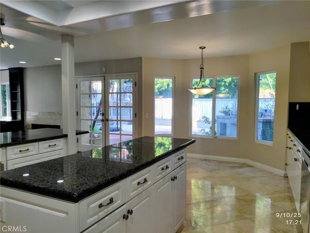 a kitchen with stainless steel appliances granite countertop a stove a sink and a granite counter tops