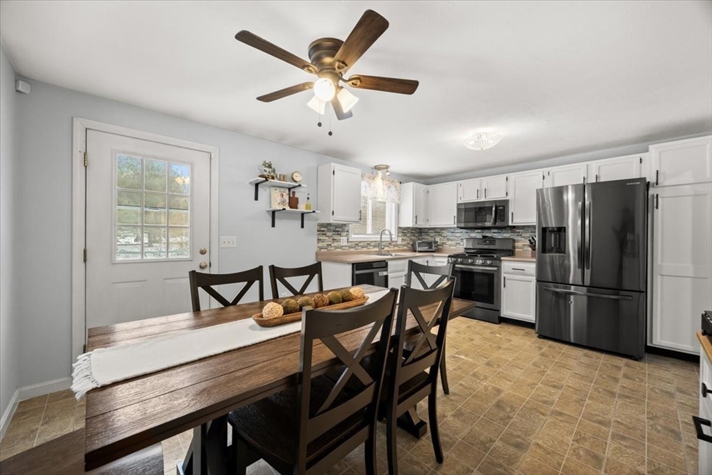 143 Morrison Road East Taunton, MA 02718 - Photo 11 of 31 a kitchen with stainless steel appliances a table chairs refrigerator and a window