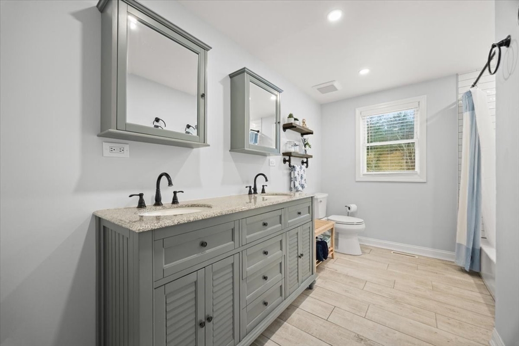 143 Morrison Road East Taunton, MA 02718 - Photo 14 of 31 a spacious bathroom with 2 sink toilet and a mirror