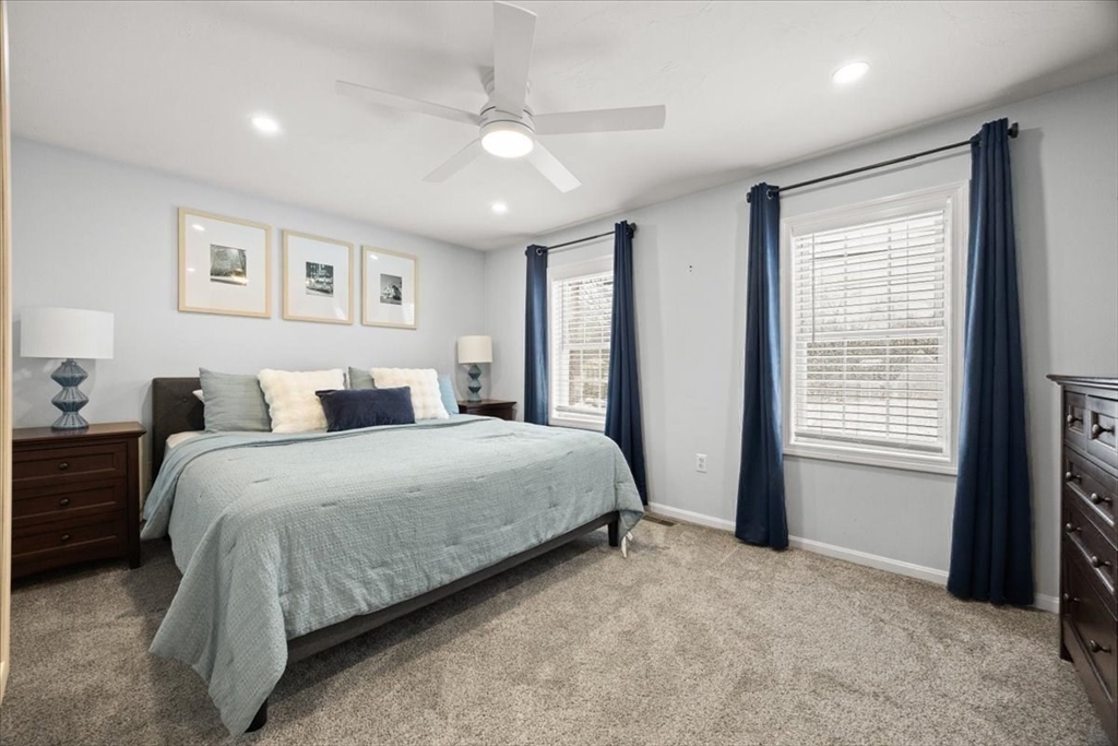 143 Morrison Road East Taunton, MA 02718 - Photo 16 of 31 a spacious bedroom with a bed and a chandelier