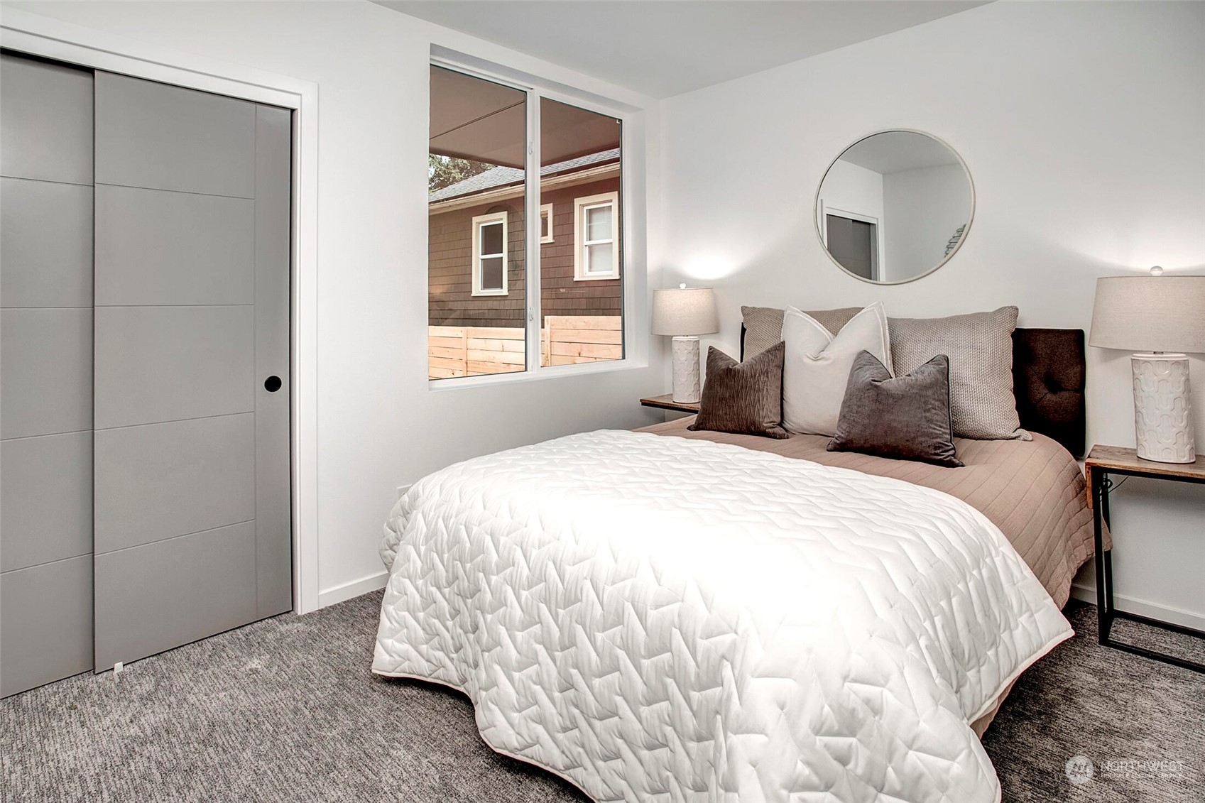 4020 Midvale Avenue North Seattle, WA 98103 - Photo 4 of 28 a bedroom with bed and a large mirror next to a window