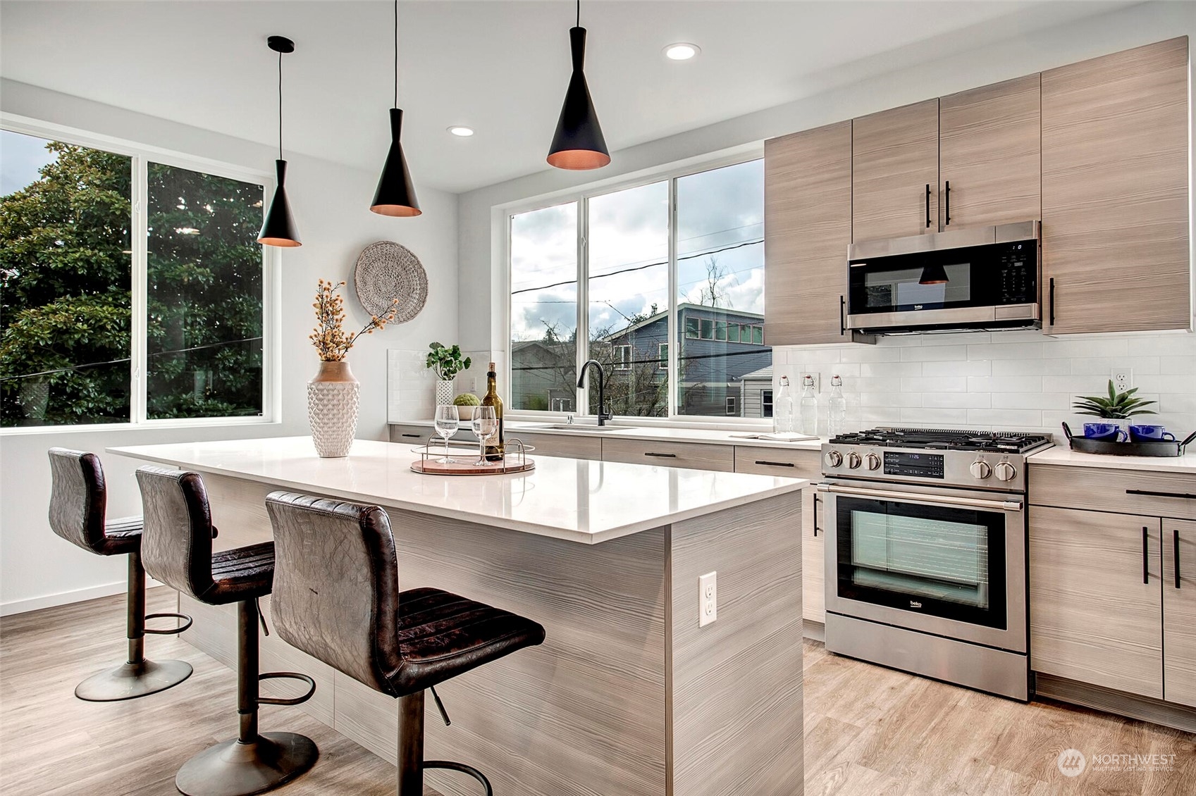 4020 Midvale Avenue North Seattle, WA 98103 - Photo 9 of 28 a kitchen with stainless steel appliances a stove a sink and a microwave