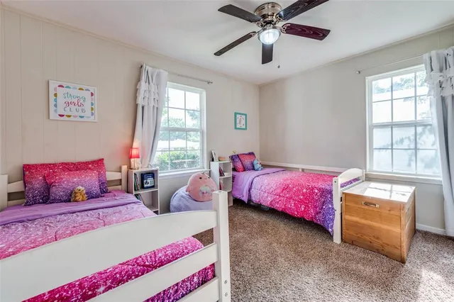 a bedroom with two beds and a chandelier