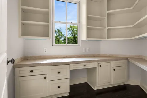 an empty room with windows and closet