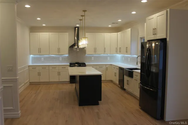 a kitchen with kitchen island a sink a counter top space and appliances
