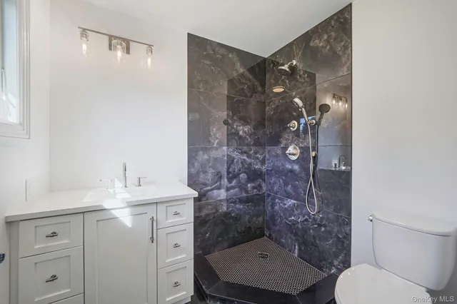 a bathroom with a sink toilet and shower