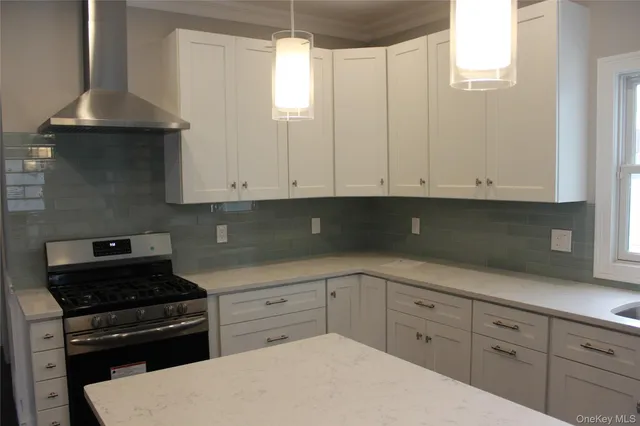 a kitchen with granite countertop white cabinets and white appliances