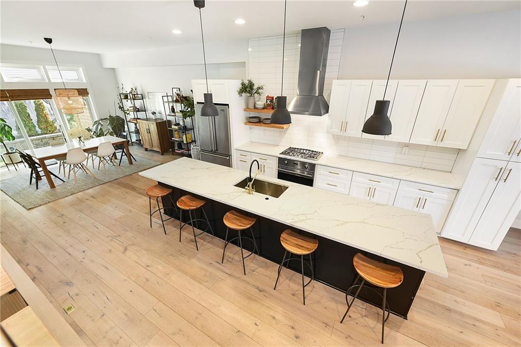 313 38th Street Pittsburgh, PA 15201 - Photo 11 of 25 a living room with stainless steel appliances kitchen island granite countertop furniture and a wooden floor