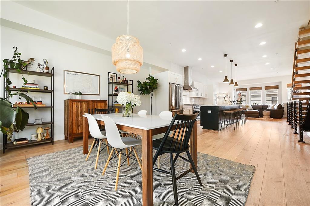 313 38th Street Pittsburgh, PA 15201 - Photo 13 of 25 a dining room with stainless steel appliances a table and chairs with wooden floor