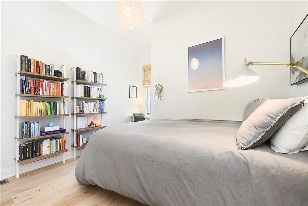 313 38th Street Pittsburgh, PA 15201 - Photo 20 of 25 a bedroom with a bed and a book shelf
