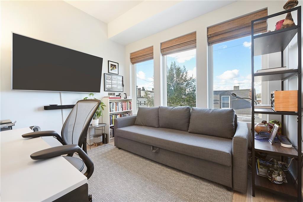 313 38th Street Pittsburgh, PA 15201 - Photo 22 of 25 a living room with furniture and a flat screen tv