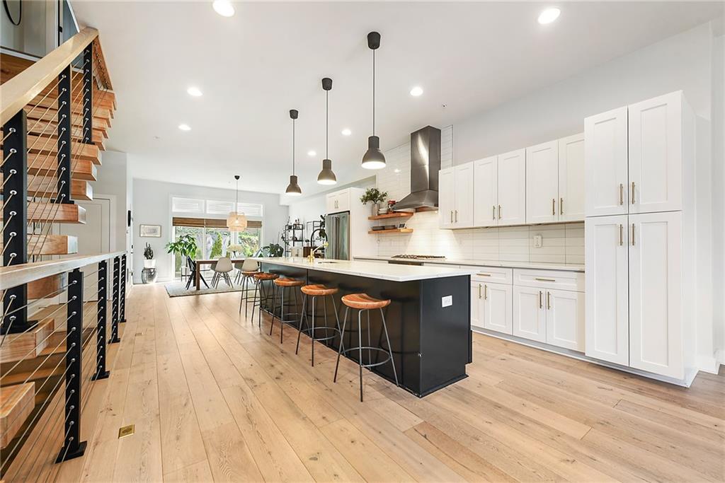 313 38th Street Pittsburgh, PA 15201 - Photo 4 of 25 a kitchen with stainless steel appliances granite countertop a lot of counter space and wooden floors
