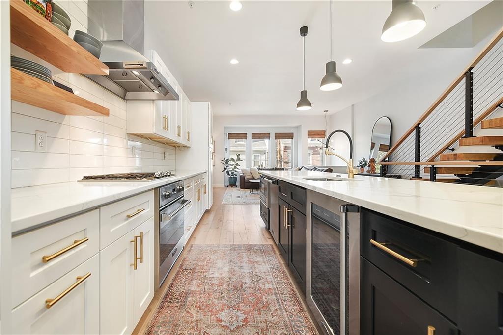 313 38th Street Pittsburgh, PA 15201 - Photo 6 of 25 a large kitchen with stainless steel appliances kitchen island granite countertop a sink and cabinets