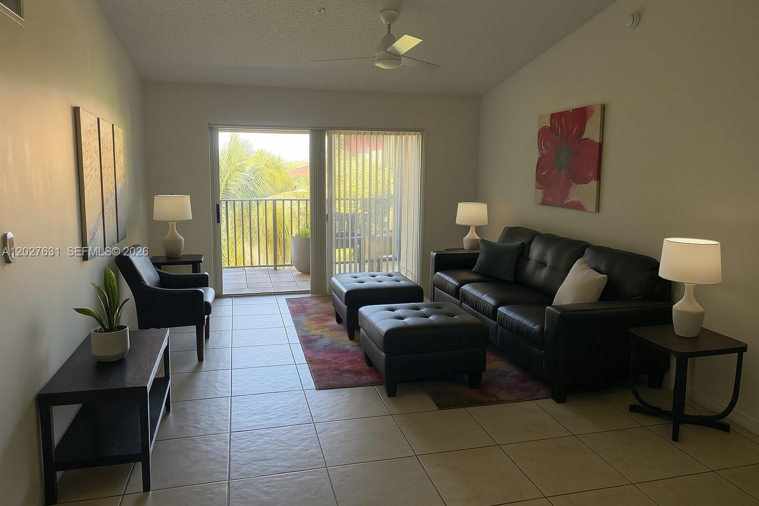 2081 Renaissance Boulevard, Unit 306 Miramar, FL 33025 - Photo 2 of 22 a living room with furniture and a lamp