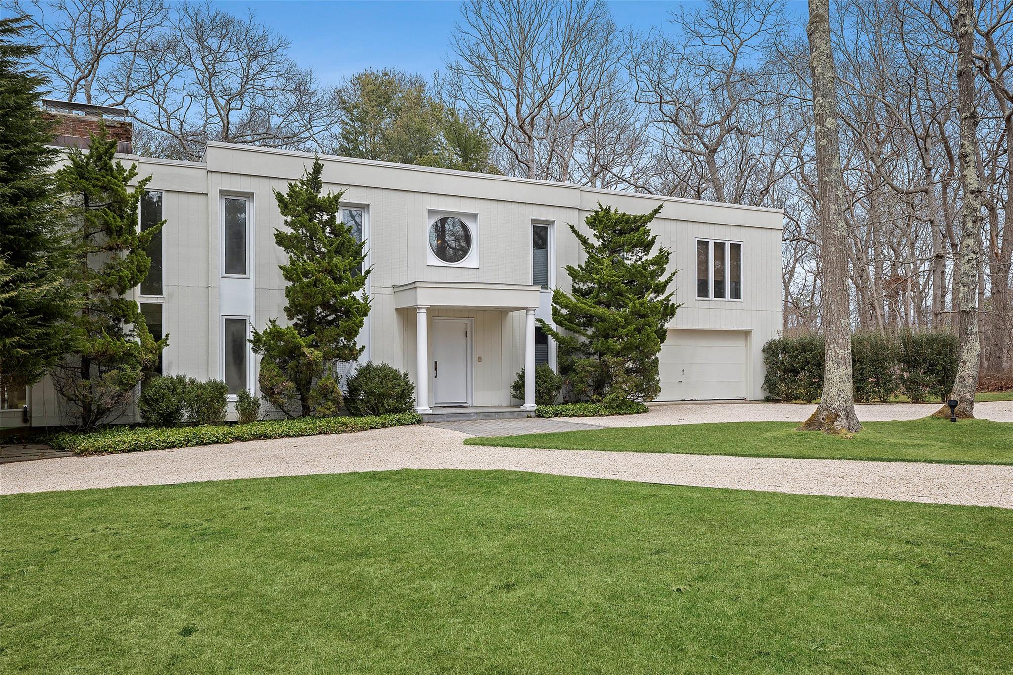 28 Georgica Close Road East Hampton, NY 11937 - Photo 17 of 23 View of front of property featuring concrete driveway, an attached garage, and a front lawn