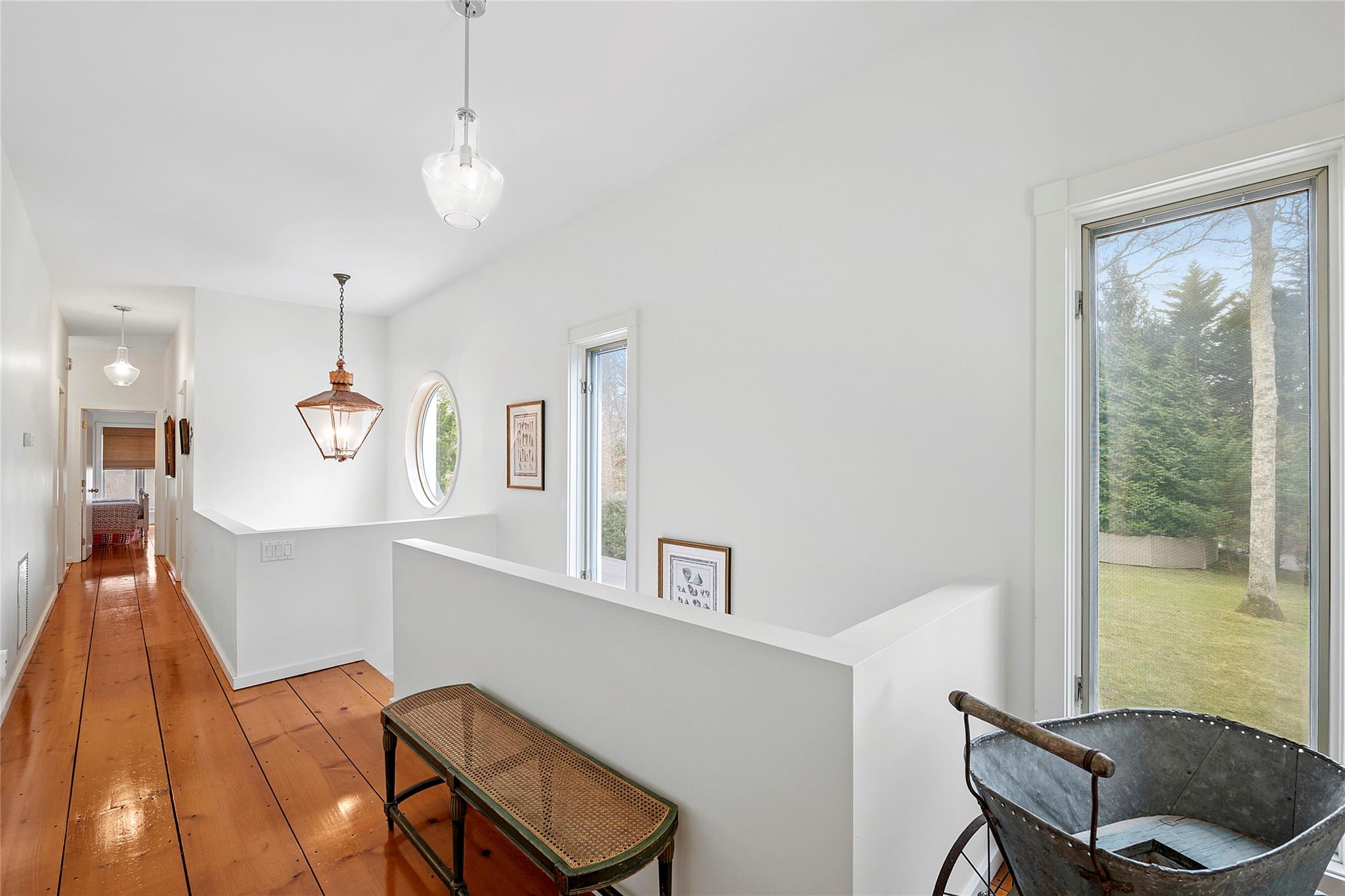 28 Georgica Close Road East Hampton, NY 11937 - Photo 7 of 23 Corridor with baseboards, an upstairs landing, and light wood-style floors
