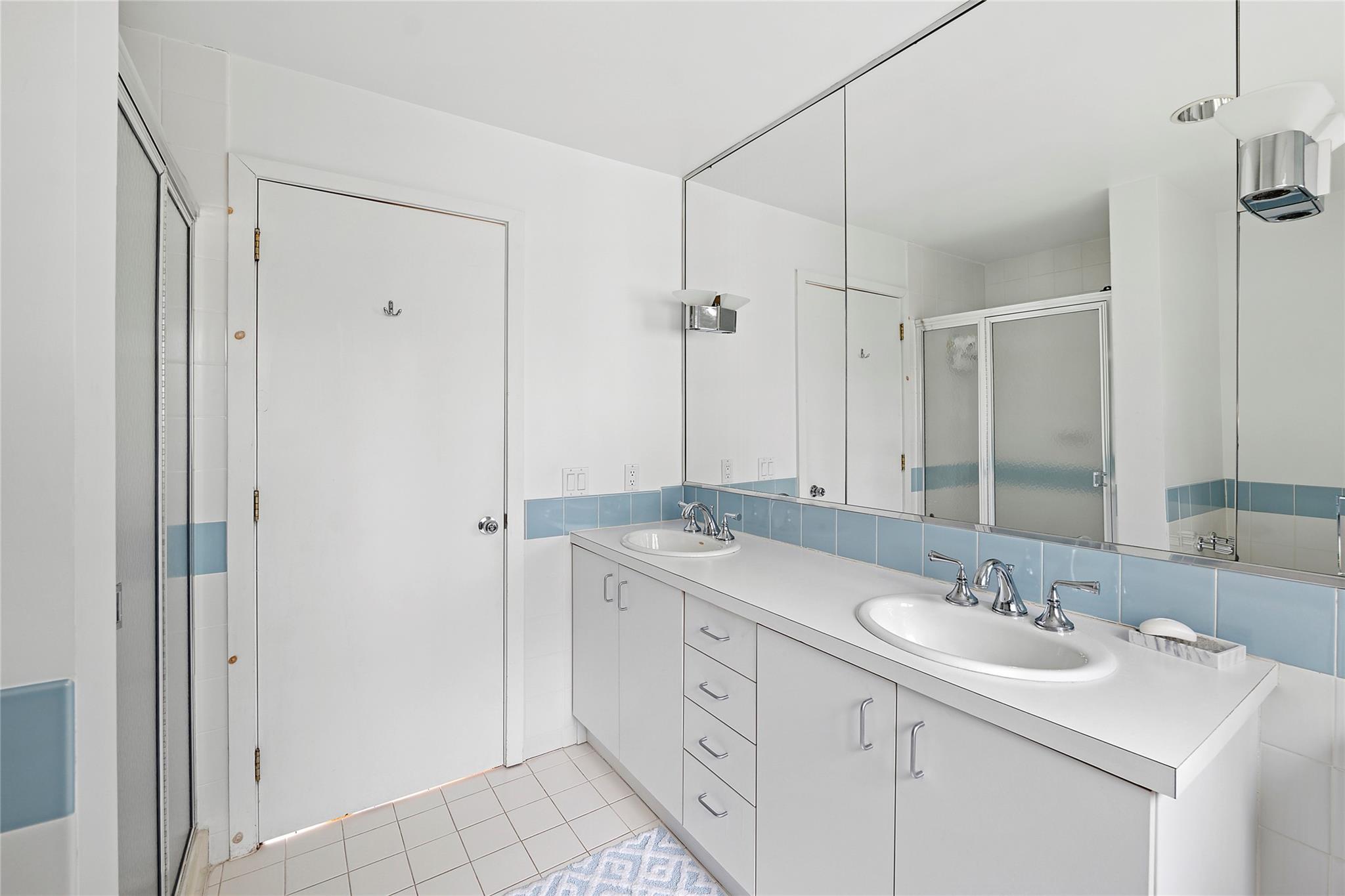 28 Georgica Close Road East Hampton, NY 11937 - Photo 10 of 23 Full bath with a stall shower, double vanity, a sink, and tile patterned floors