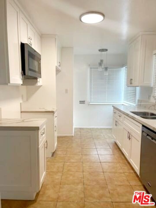 3760 Wellington Road Los Angeles, CA 90016 - Photo 24 of 52 a kitchen with stainless steel appliances granite countertop a sink and a stove top oven