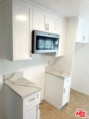 a kitchen with granite countertop a sink and a stove