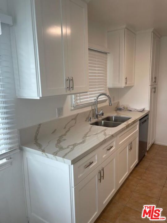 3760 Wellington Road Los Angeles, CA 90016 - Photo 27 of 52 a kitchen with white cabinets and sink
