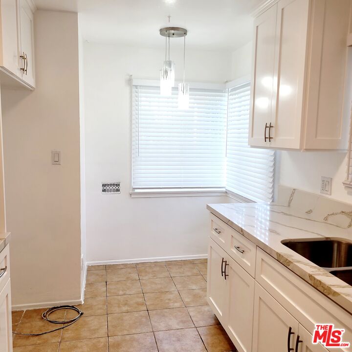 3760 Wellington Road Los Angeles, CA 90016 - Photo 29 of 52 a kitchen with a sink window and cabinets