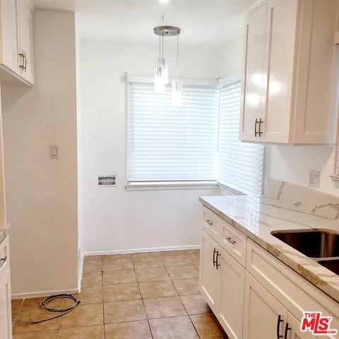 a kitchen with a sink a stove and cabinets