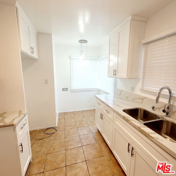 3760 Wellington Road Los Angeles, CA 90016 - Photo 32 of 52 a kitchen with a sink a stove and cabinets