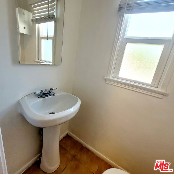 3760 Wellington Road Los Angeles, CA 90016 - Photo 34 of 52 a white sink sitting under a bathroom window