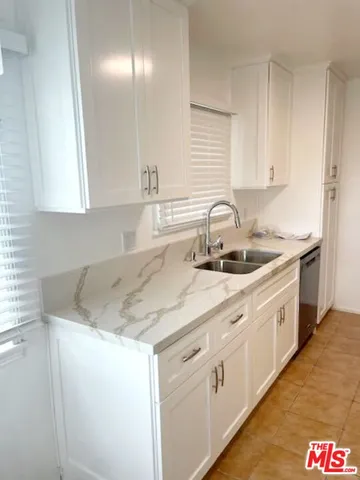 a view of a house with a yard and pathway