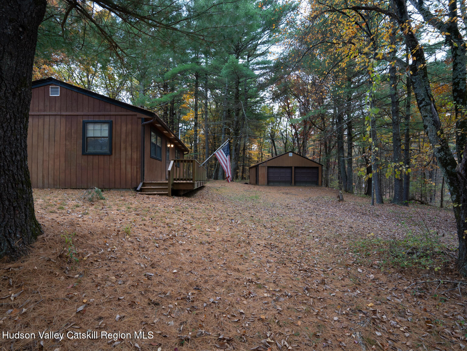 386 Fowler Lake Road Ghent, NY 12075 - Photo 22 of 24 a view of a backyard with large trees and a small barn