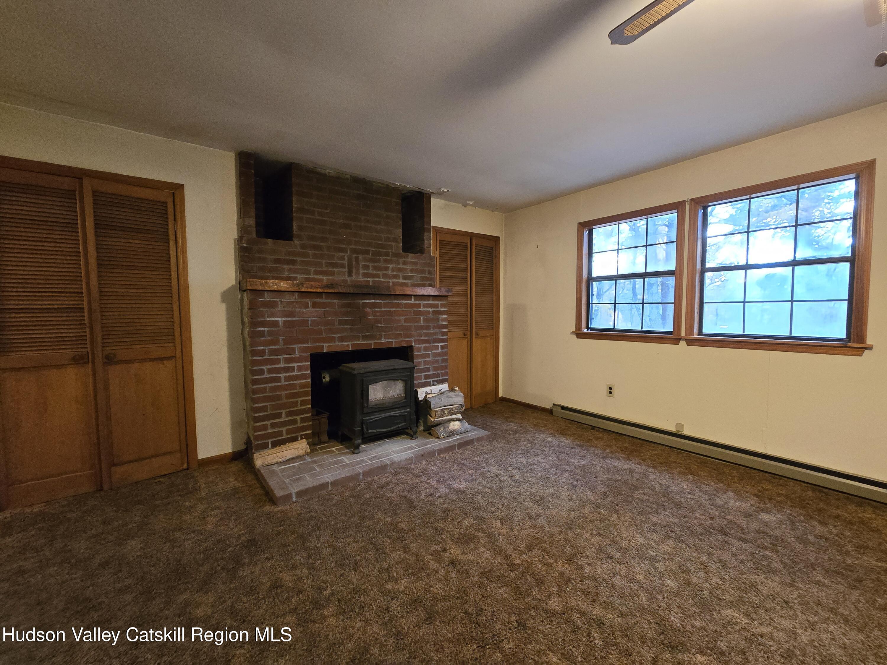 386 Fowler Lake Road Ghent, NY 12075 - Photo 4 of 24 an empty room with windows
