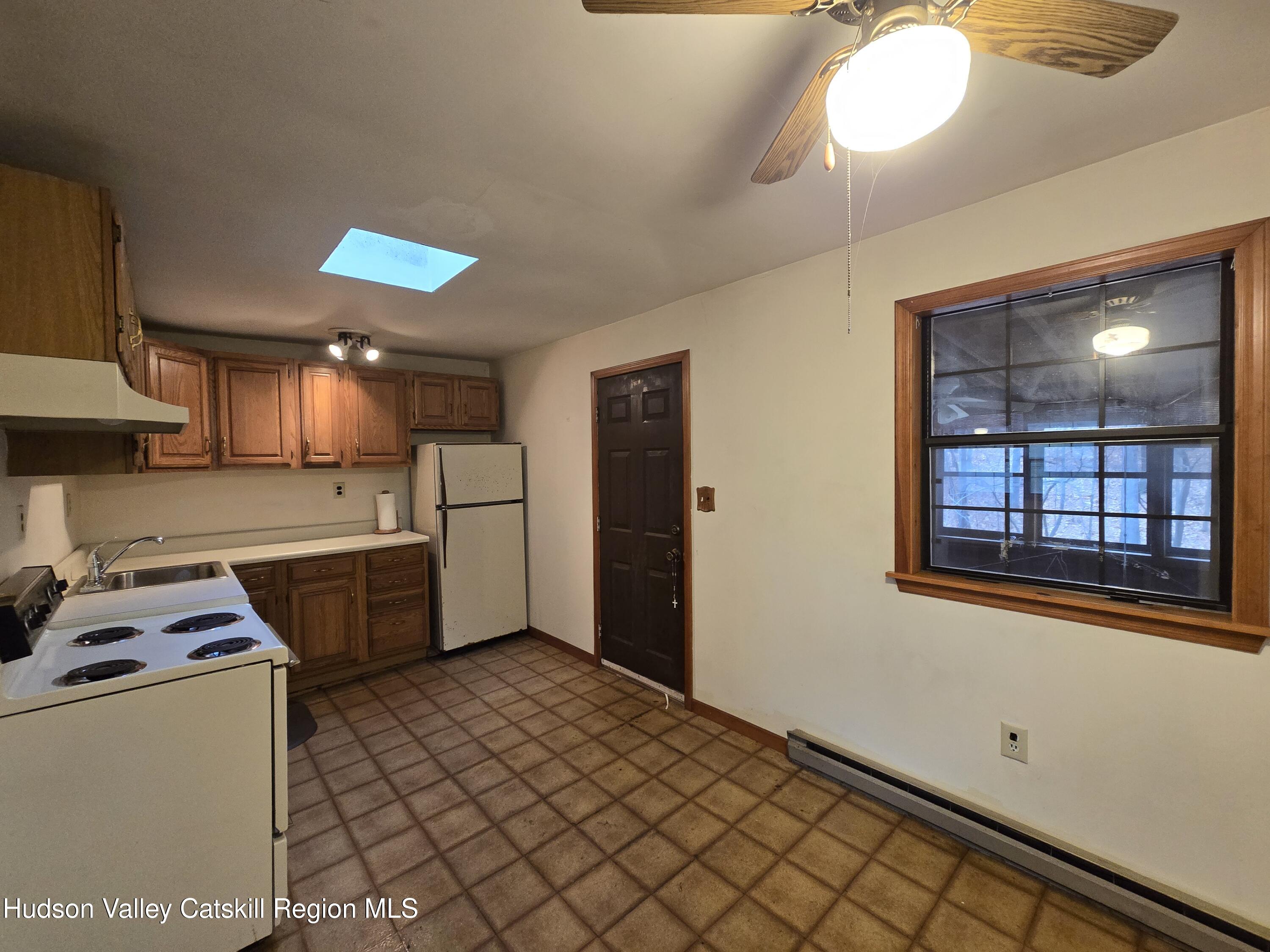 386 Fowler Lake Road Ghent, NY 12075 - Photo 7 of 24 a kitchen with a cabinets and window