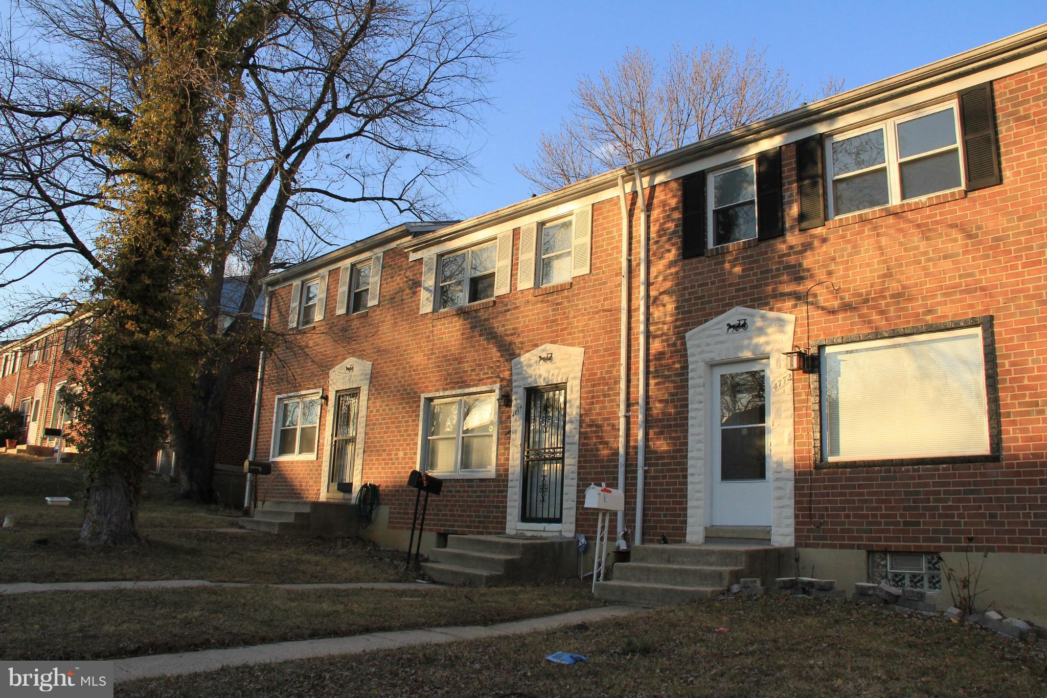 4772 Melbourne Road Baltimore, MD 21229 - Photo 2 of 30 a front view of a house with a yard