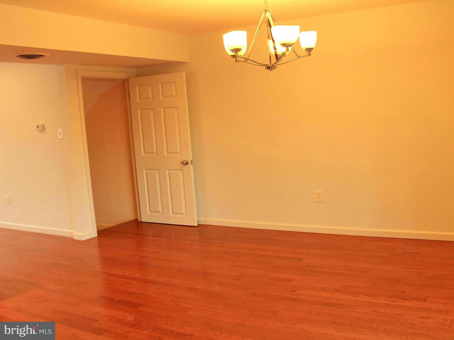 4772 Melbourne Road Baltimore, MD 21229 - Photo 13 of 30 a view of empty room with wooden floor