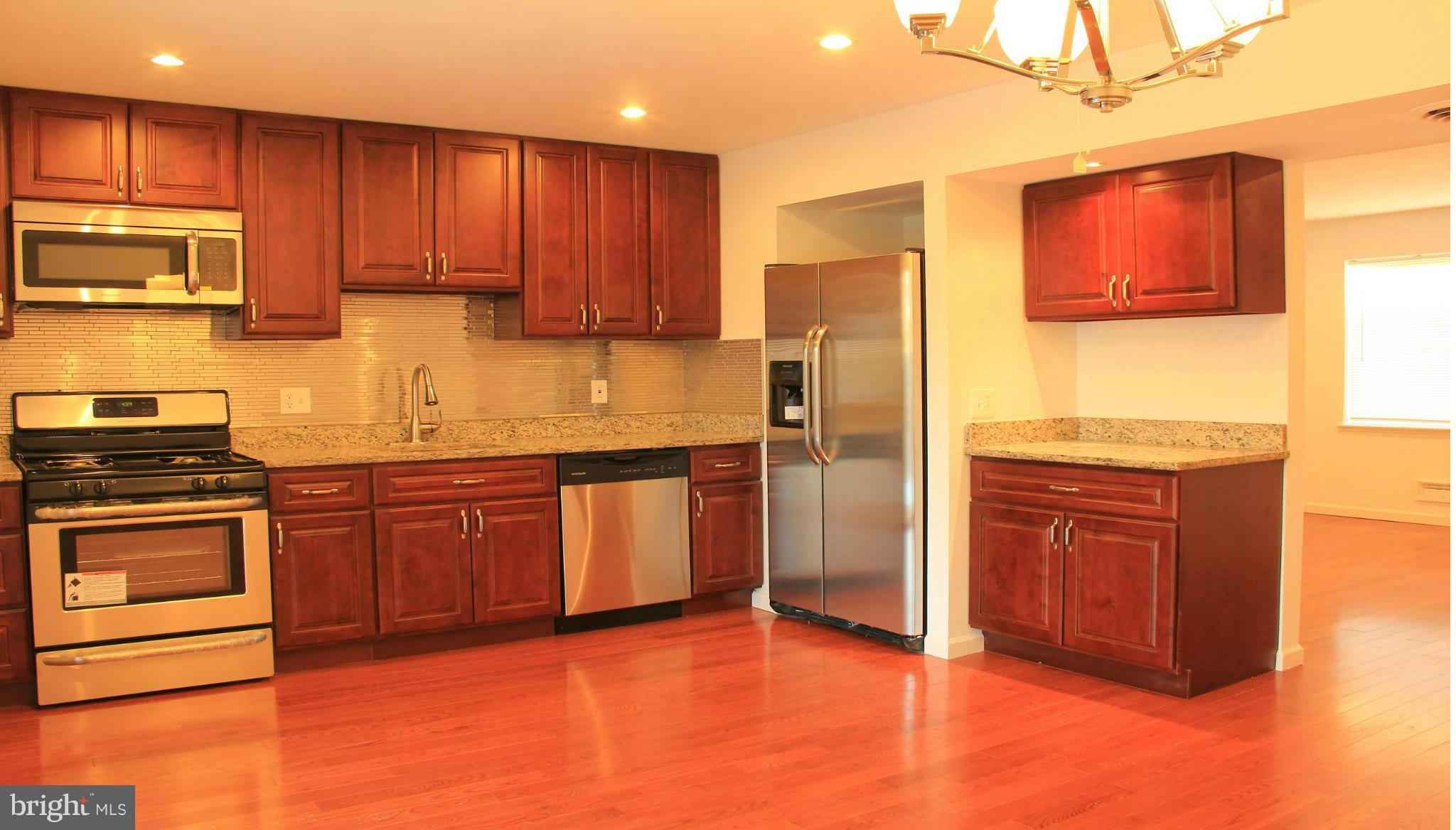 4772 Melbourne Road Baltimore, MD 21229 - Photo 14 of 30 a kitchen with stainless steel appliances granite countertop a refrigerator stove top oven and sink