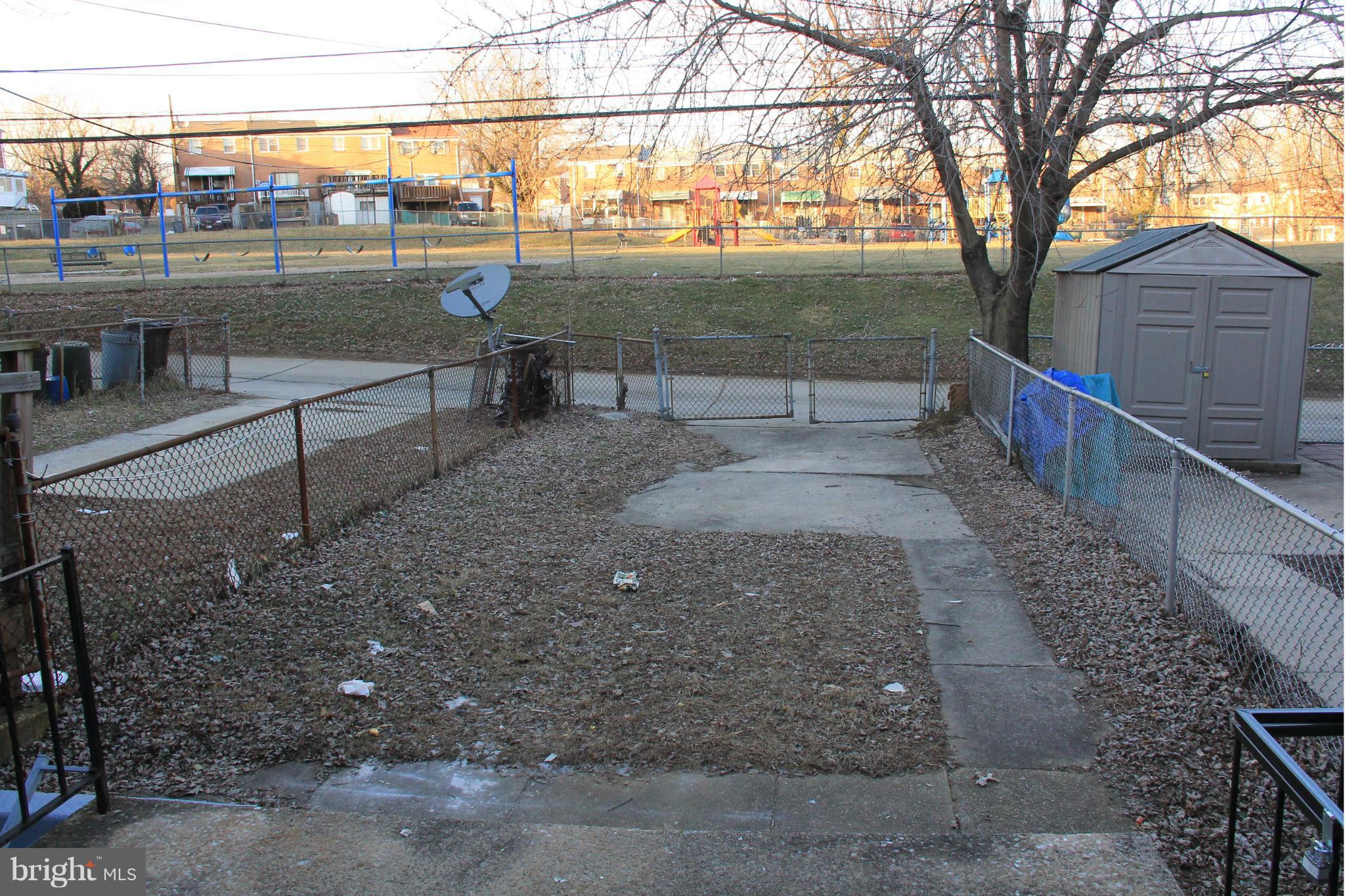 4772 Melbourne Road Baltimore, MD 21229 - Photo 20 of 30 a view of a street with a tree next to it