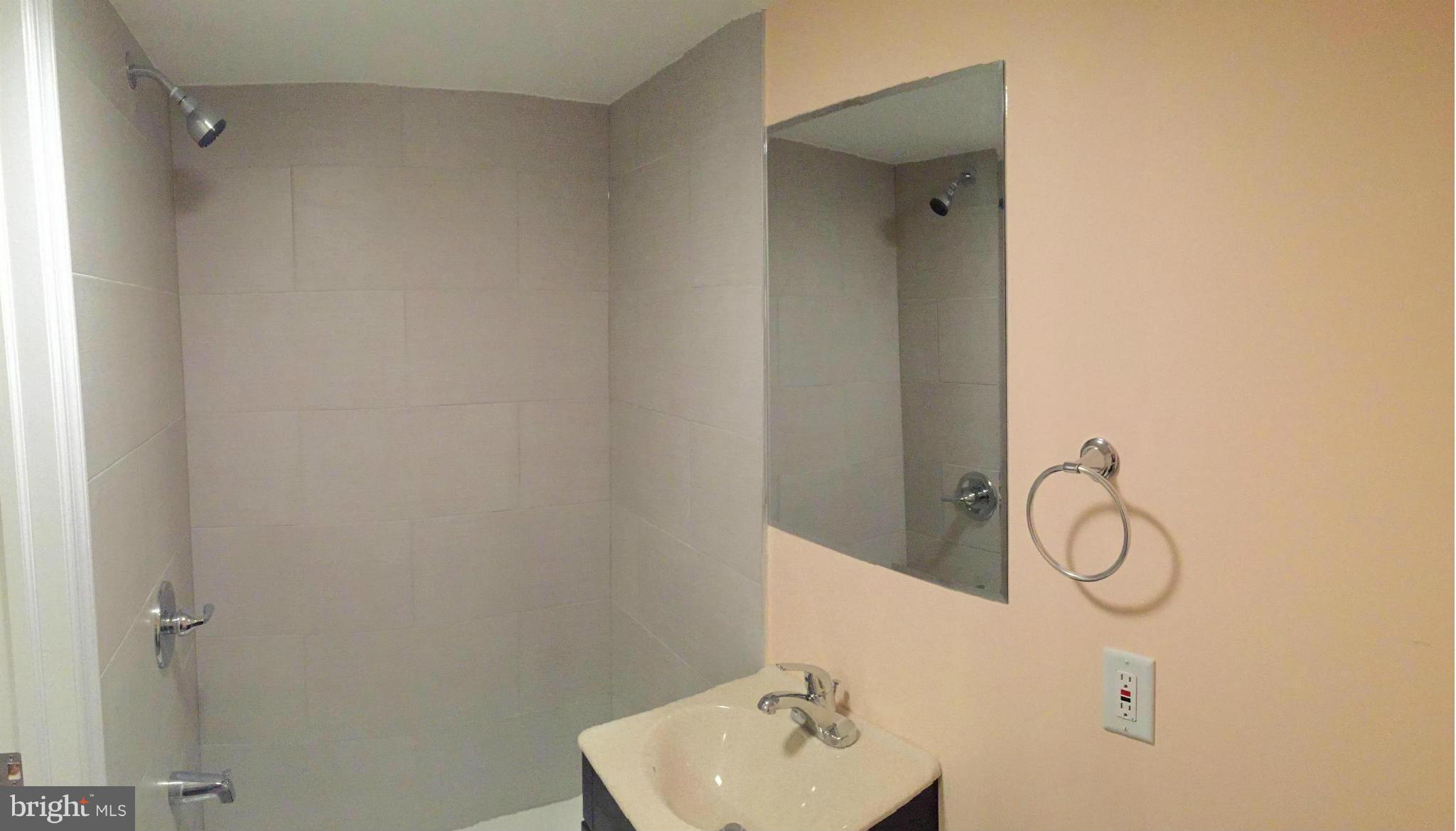 4772 Melbourne Road Baltimore, MD 21229 - Photo 24 of 30 a bathroom with a shower and vanity