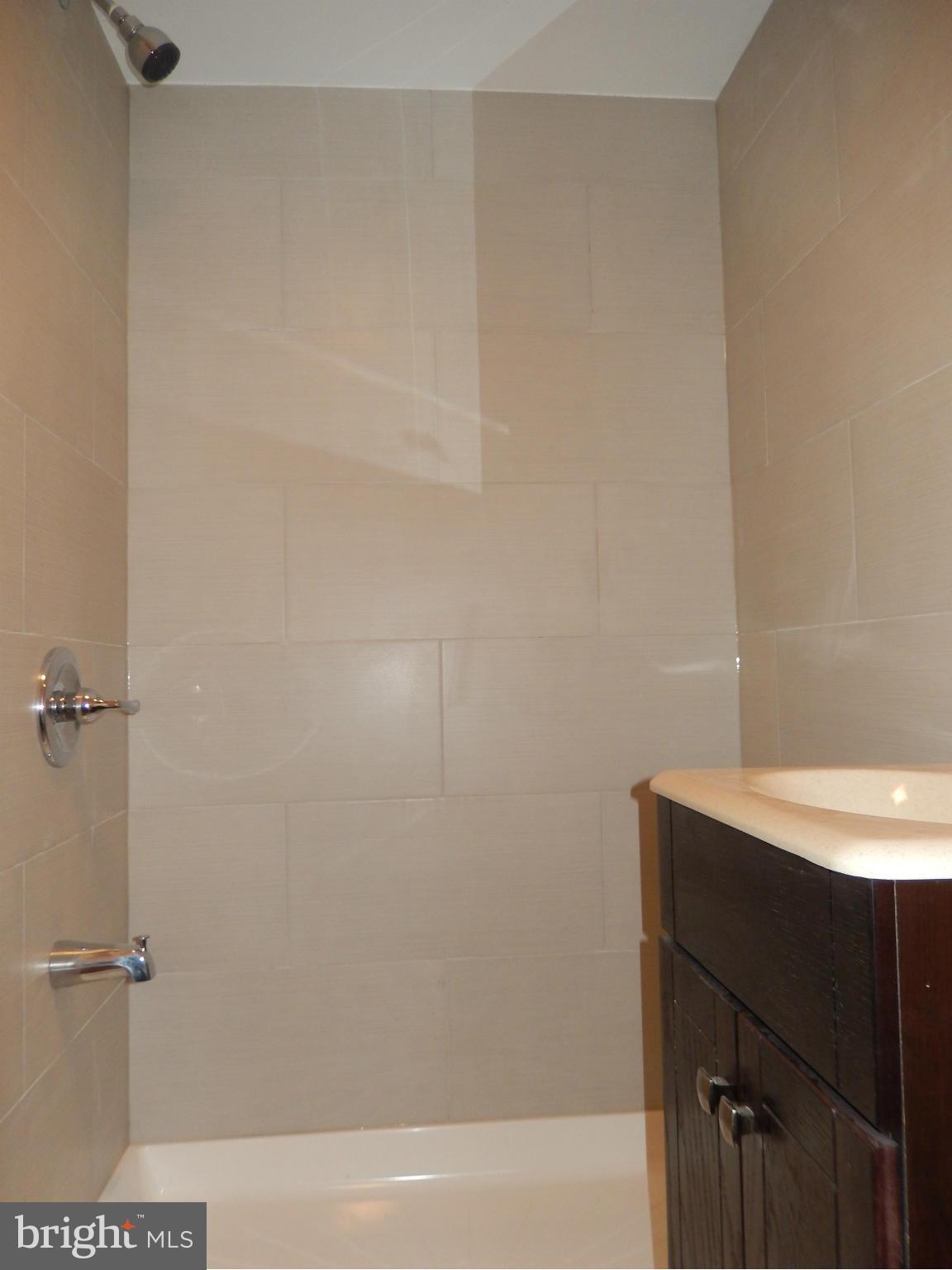 4772 Melbourne Road Baltimore, MD 21229 - Photo 25 of 30 a bathroom with a sink and a shower