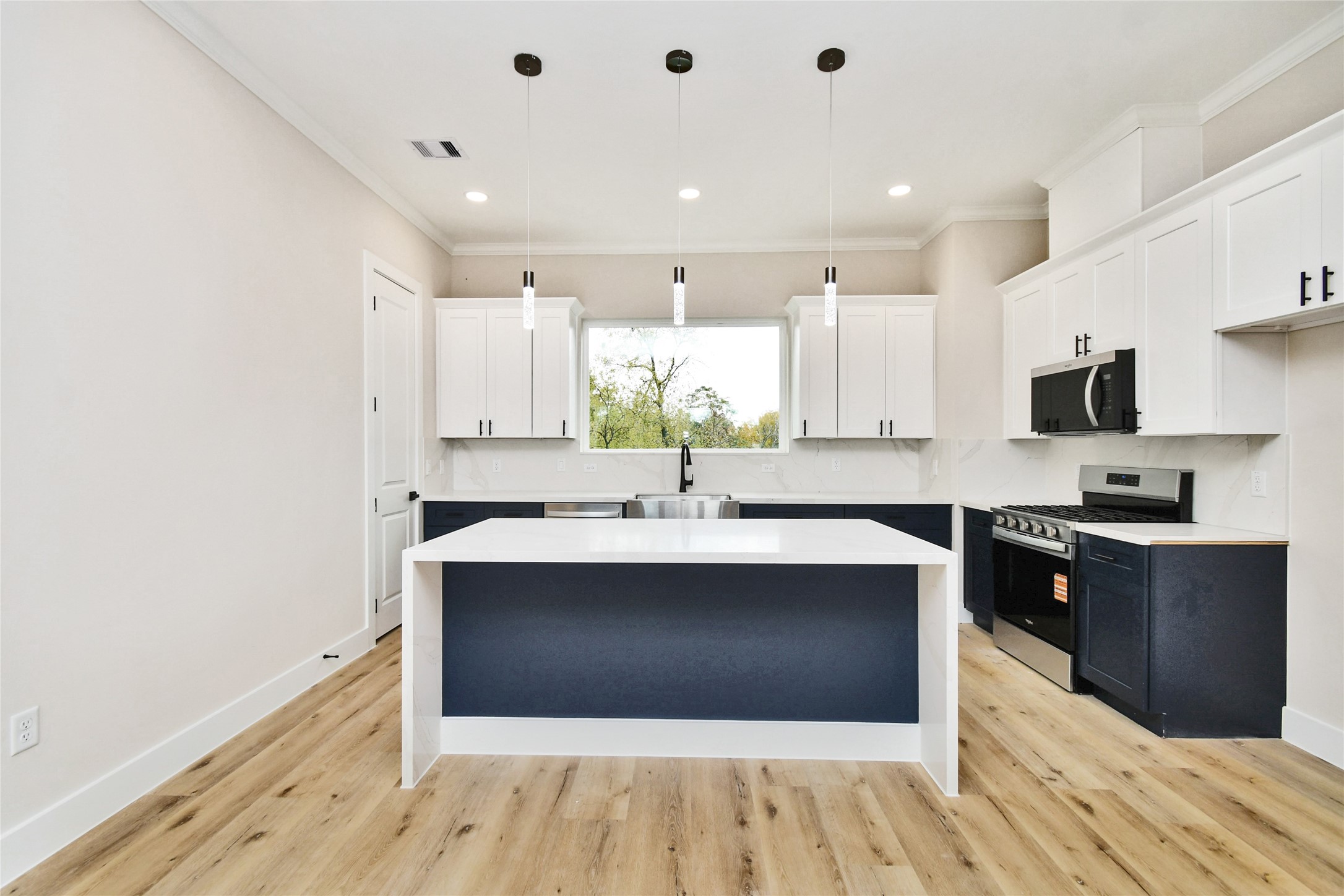 3231 Tuam Street Houston, TX 77004 - Photo 15 of 47 a large kitchen with stainless steel appliances a sink and cabinets