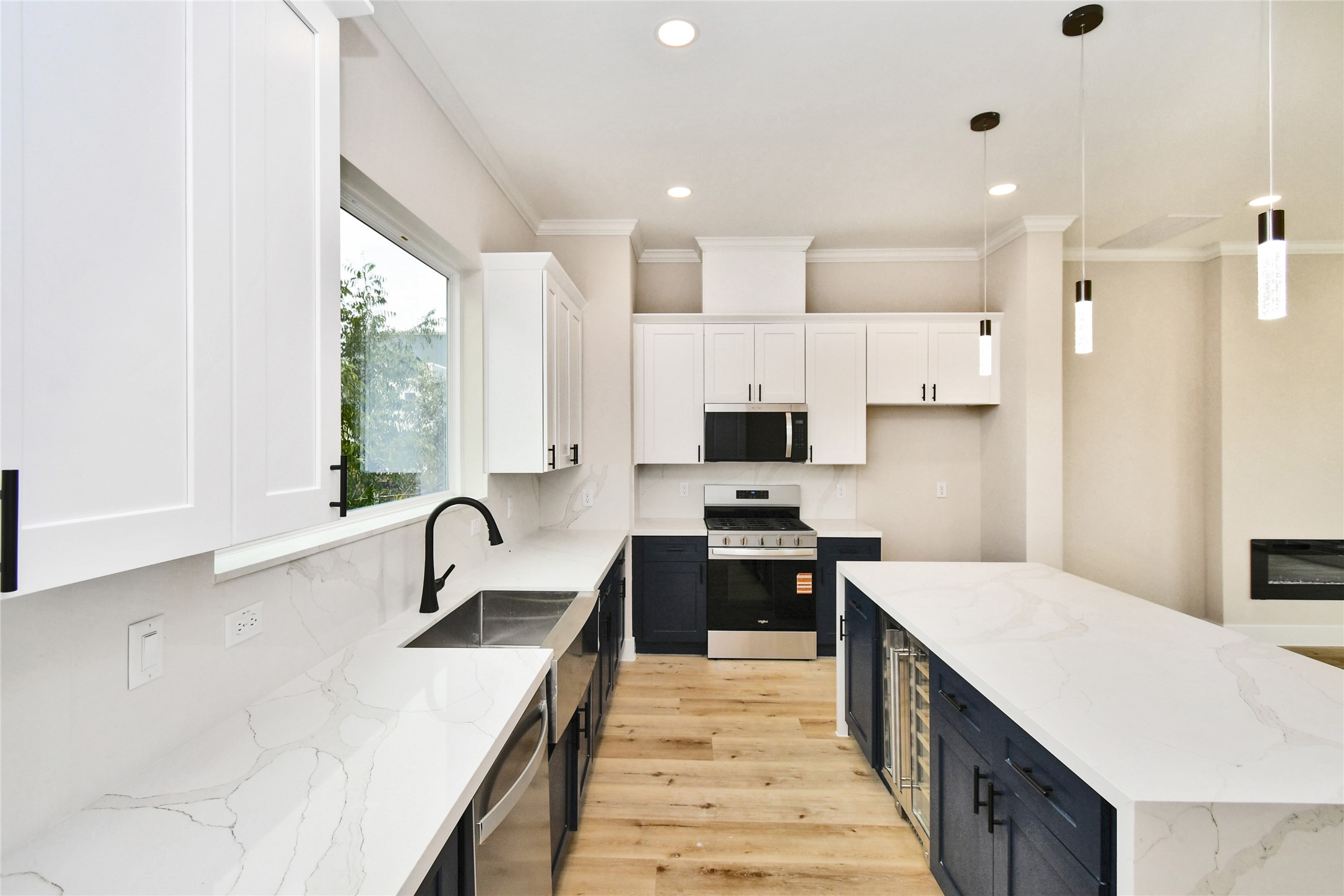 3231 Tuam Street Houston, TX 77004 - Photo 17 of 47 a large kitchen with stainless steel appliances a sink a stove and a refrigerator