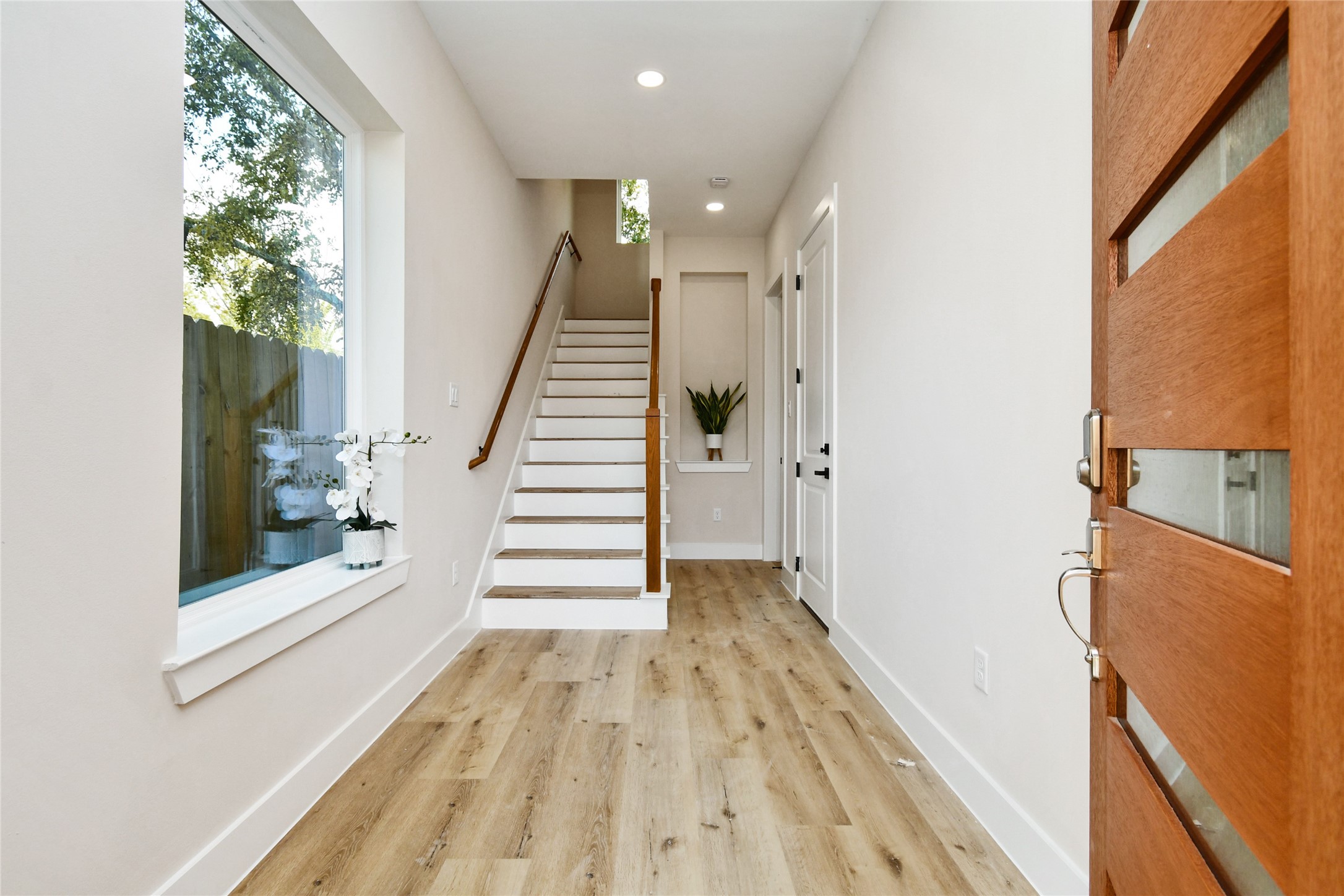 3231 Tuam Street Houston, TX 77004 - Photo 3 of 47 a view of a hallway with wooden floor and staircase