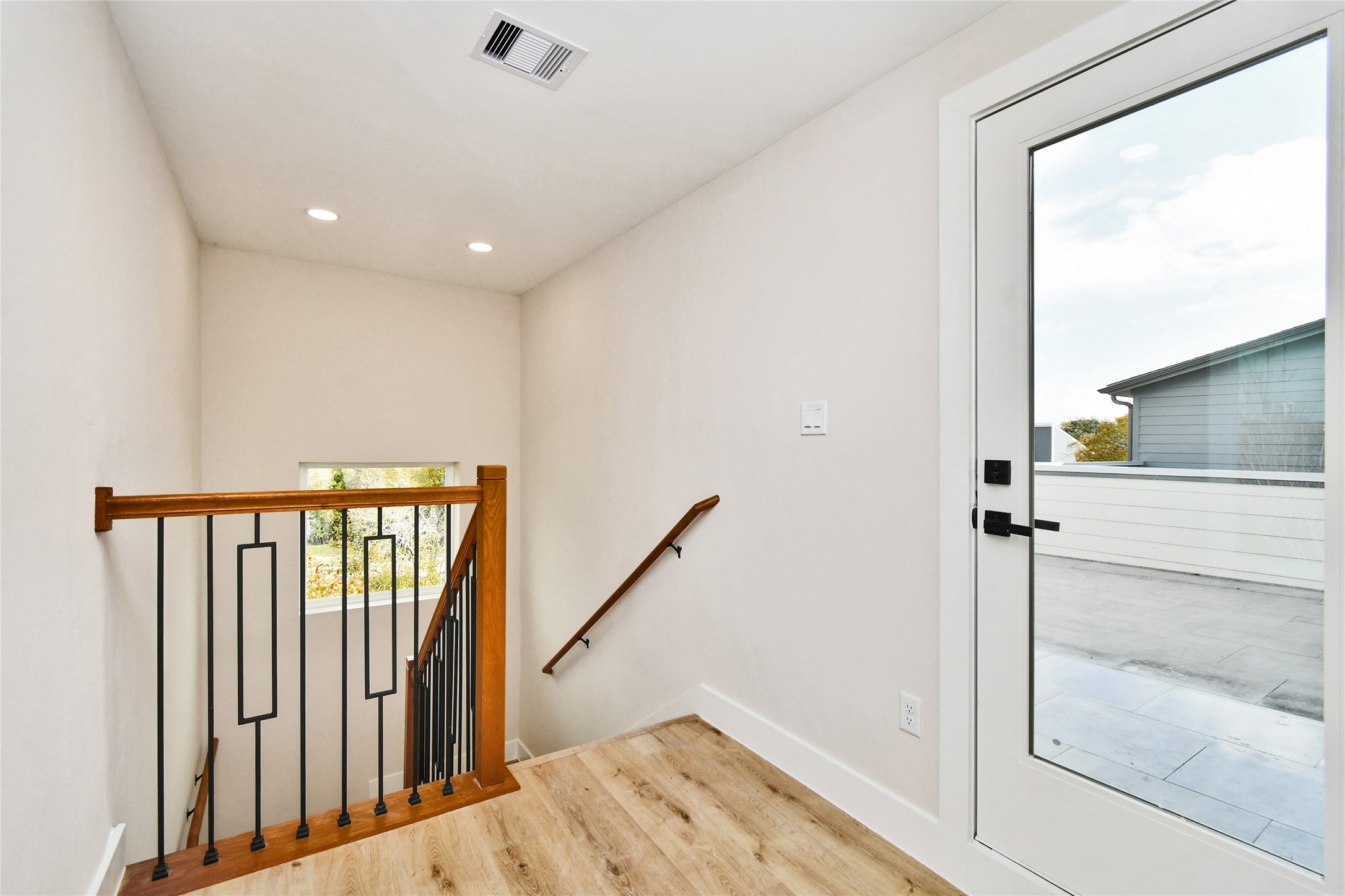 3231 Tuam Street Houston, TX 77004 - Photo 36 of 47 a view of a hallway with wooden floor and staircase