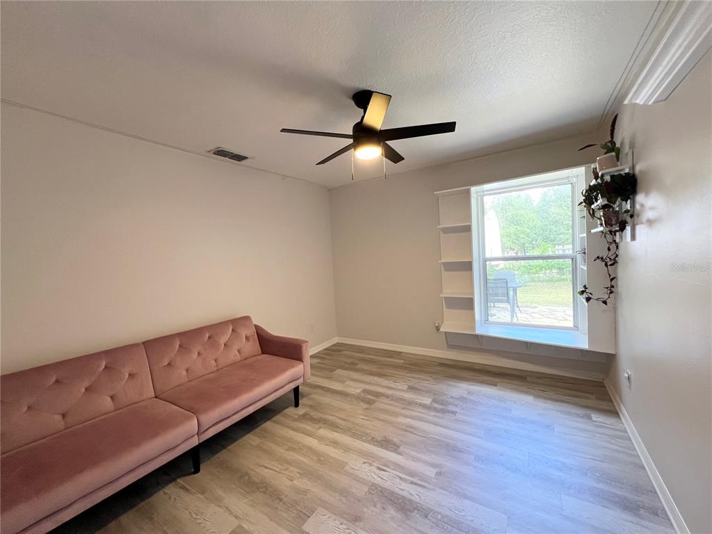 14906 Windy Mt Circle Clermont, FL 34711 - Photo 15 of 26 a living room with couch and a window