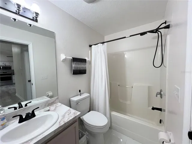 a bathroom with a sink toilet tub and shower
