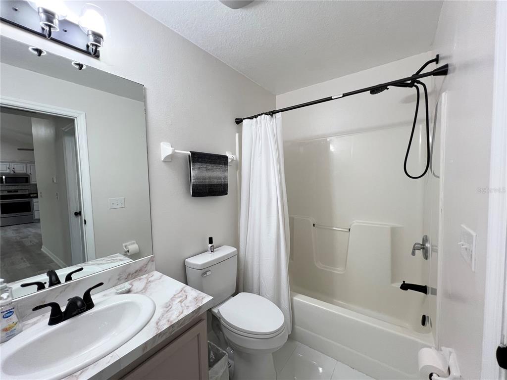 14906 Windy Mt Circle Clermont, FL 34711 - Photo 17 of 26 a bathroom with a sink toilet tub and shower