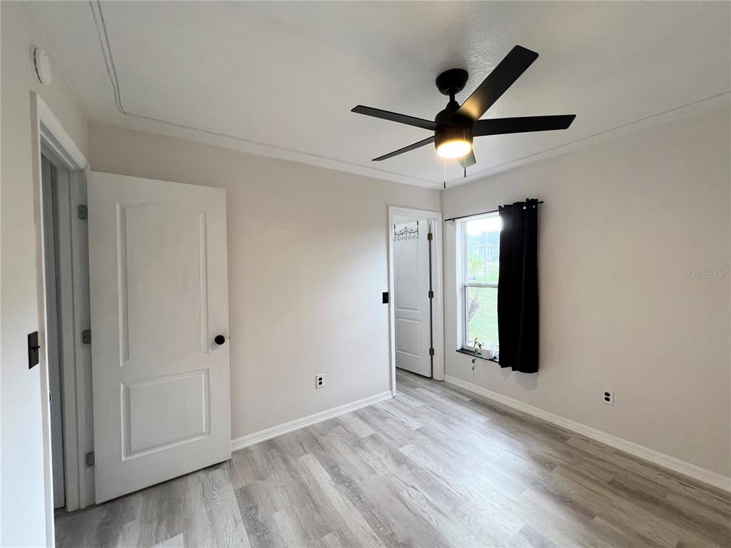 14906 Windy Mt Circle Clermont, FL 34711 - Photo 18 of 26 a view of a livingroom with a ceiling fan & window