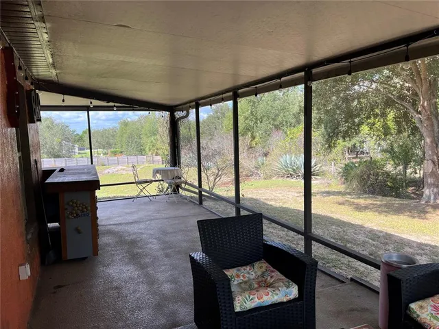 a living room with couch and a floor to ceiling window