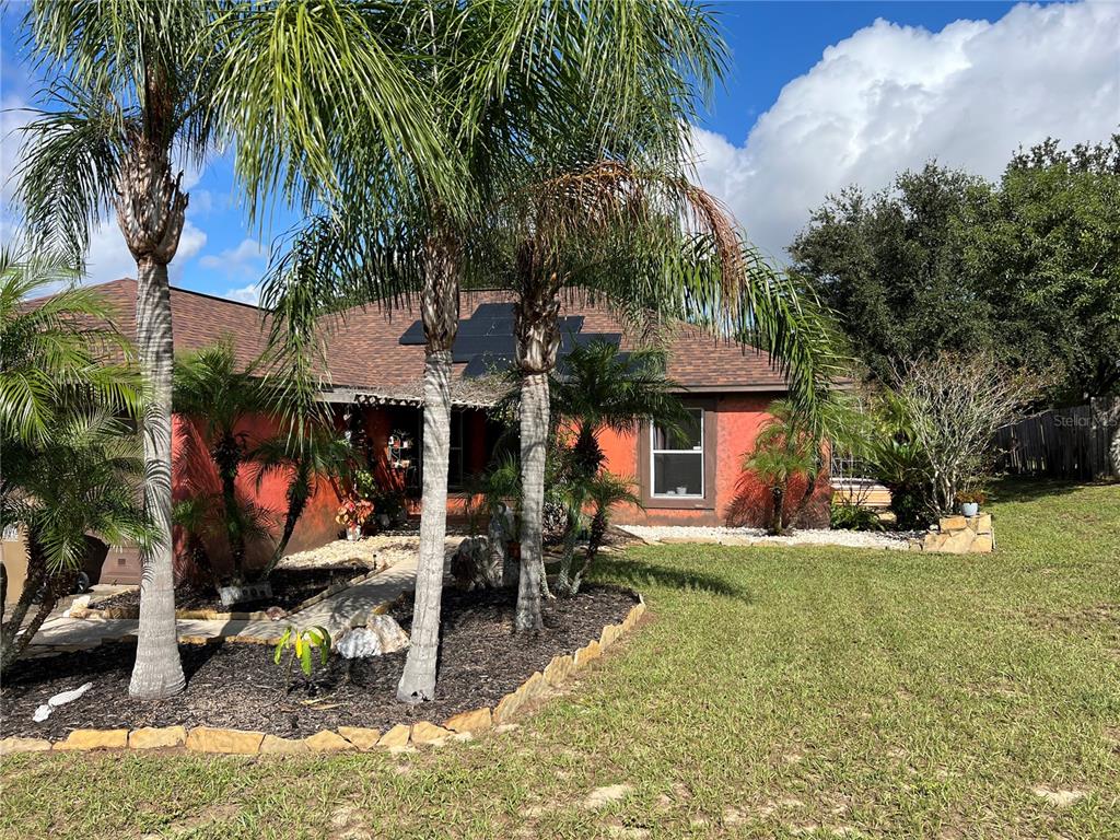 14906 Windy Mt Circle Clermont, FL 34711 - Photo 2 of 26 a view of a chairs and table in a backyard