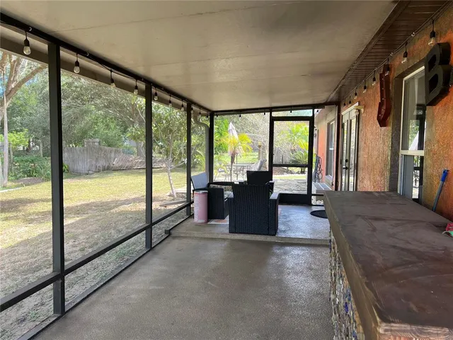 a view of a living room and floor to ceiling window